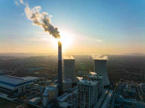 istock Aerial view power station with smoking at sunset 1365823086