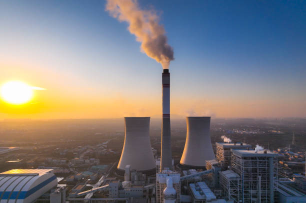 istock Aerial view power station with smoking at sunset 1365823110