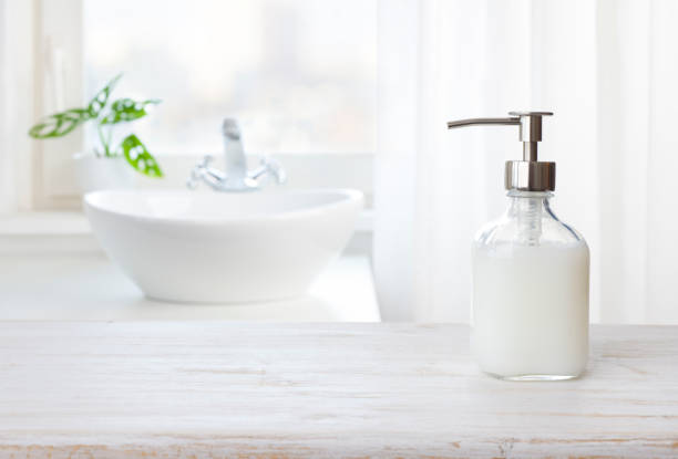 istock Soap dispenser on wooden table in bathroom with copy space 1365823880