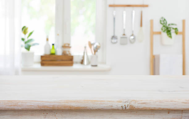 istock Wood tabletop on blur kitchen background for product display montage 1365823946
