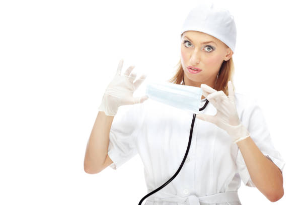 Doctor with protective mask and gloves against white background