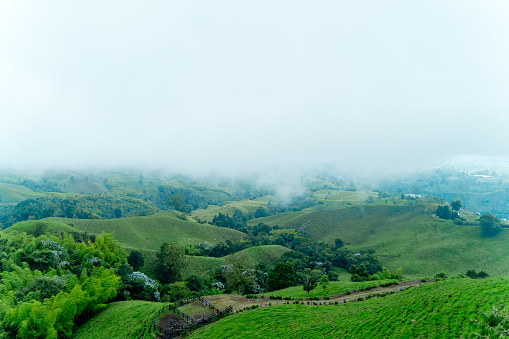 Panoramic view of mountains and clouds in Filandia valley and green scenery. Colombia landscapes concept.