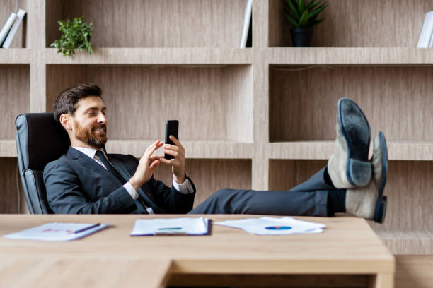 istock Businessman sitting at computer desk in the office 1365824892