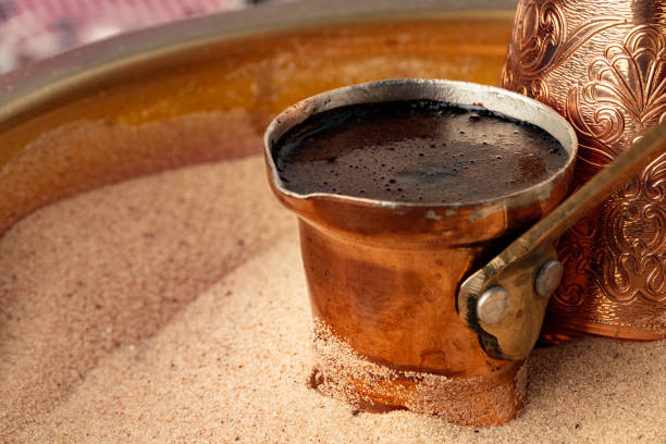 istock Copper turk with coffee brewing in sand 1365825071