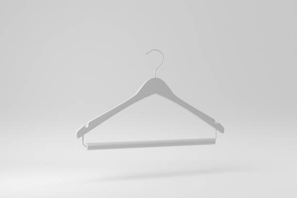 Shopping and style concept - clothes rack with trendy blue jacket and pants, bag on wooden floor and grey concrete background. Vertical photo