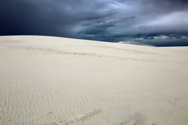 Photo of White dune and cloudy sky