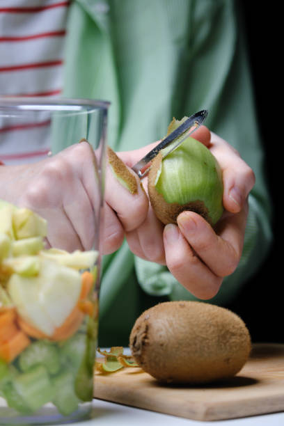 istock Peeling a kiwi fruit for detox smoothie 1365835794