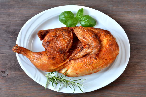 half of the rotisserie chicken half of the rotisserie chicken halved stock pictures, royalty-free photos & images