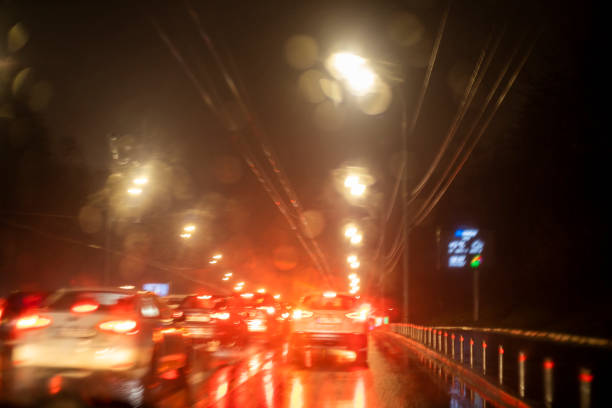 istock abstract blurred background on the windshield of a car with bright lights during a traffic jam in the rain 1365838925