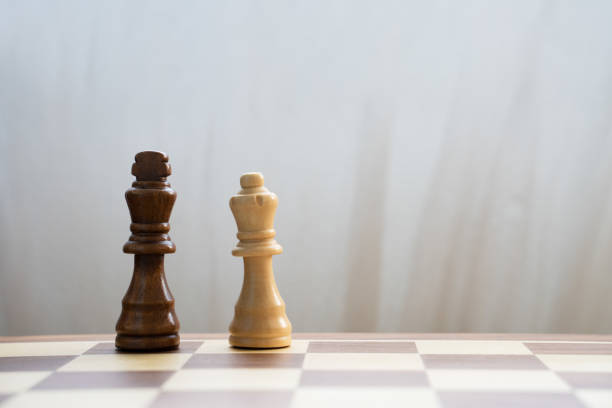 istock Black king and white queen on chess board 1365839351