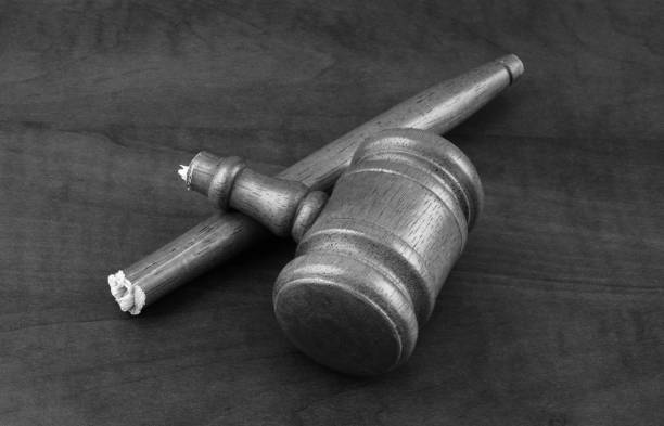 Broken wooden judge gavel on wooden table. Concept of iniquity, injustice and lawlessness.