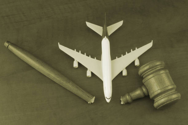 istock Broken judge gavel and airplane model on wooden background. 1365840683
