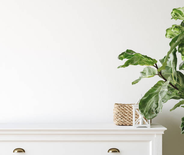istock Wall mockup close up in Coastal living room interior with commode, plant and decor 1365842435
