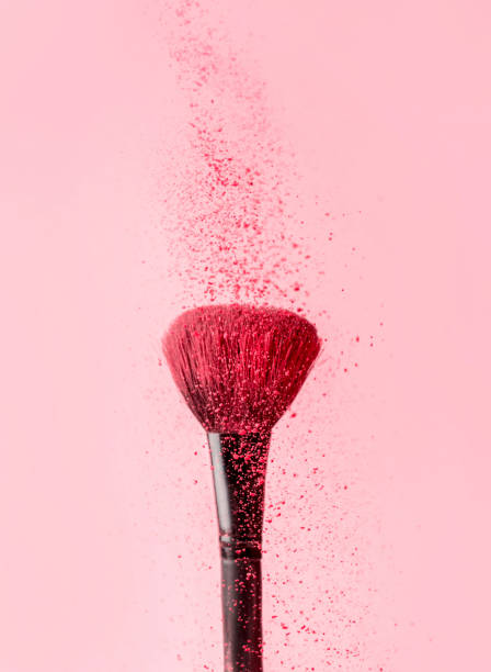 istock close-up on a blush brush with pink blush crumbling on top on a pink background 1365842886