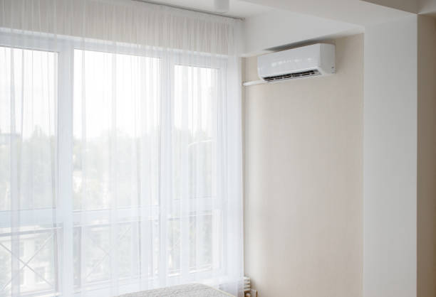 istock An air conditioner near a big window, bright room 1365843532