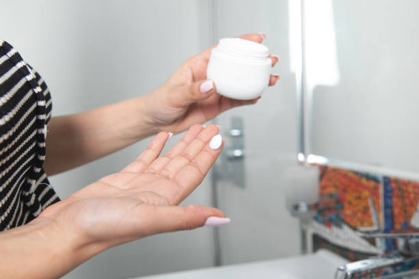 istock Woman holding plastic jar of cream. 1365845065