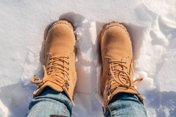 istock Yellow boots in the snow, top view 1365845654