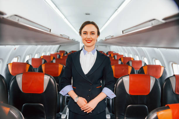 istock Empty seats. Young stewardess on the work in the passanger airplane 1365846463