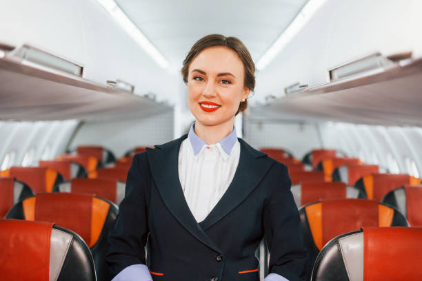 istock Empty seats. Young stewardess on the work in the passanger airplane 1365846467