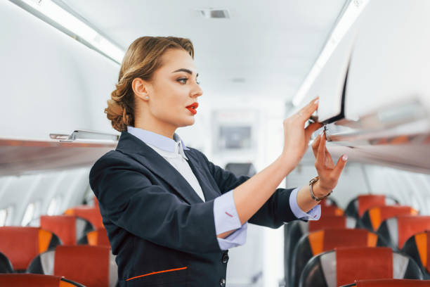 istock Empty seats. Young stewardess on the work in the passanger airplane 1365846482