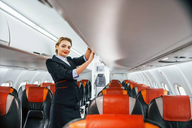 istock Empty seats. Young stewardess on the work in the passanger airplane 1365846508