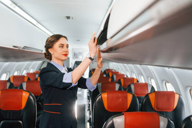istock Empty seats. Young stewardess on the work in the passanger airplane 1365846520