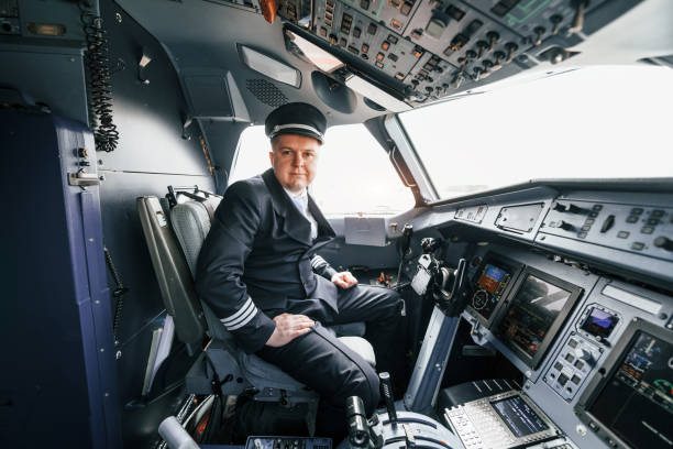 istock Pilot on the work in the passenger airplane. Preparing for takeoff 1365846858