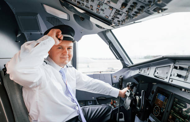 istock Pilot on the work in the passenger airplane. Preparing for takeoff 1365846883
