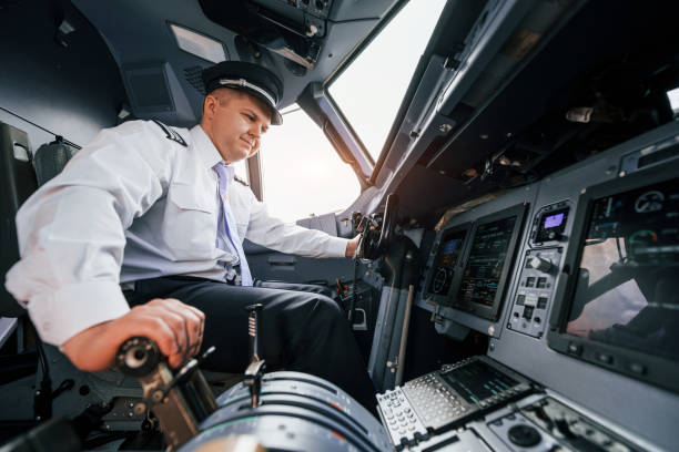 istock Pilot on the work in the passenger airplane. Preparing for takeoff 1365846915