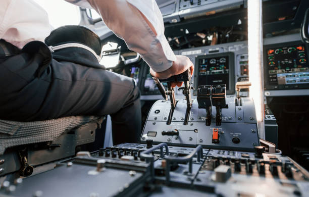 istock Control of the flight. Pilot on the work in the passenger airplane. Preparing for takeoff 1365846952