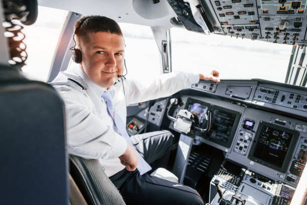 istock Pilot on the work in the passenger airplane. Preparing for takeoff 1365846966