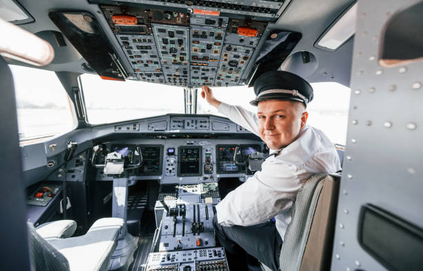 istock Control of the flight. Pilot on the work in the passenger airplane. Preparing for takeoff 1365846977