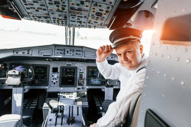 istock Control of the flight. Pilot on the work in the passenger airplane. Preparing for takeoff 1365847068