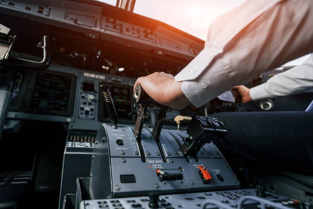 istock Control of the flight. Pilot on the work in the passenger airplane. Preparing for takeoff 1365847072
