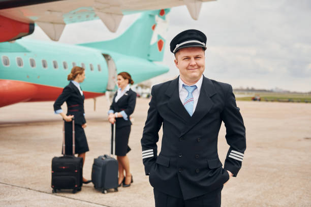 istock Aircraft crew in work uniform is together outdoors near plane 1365848400