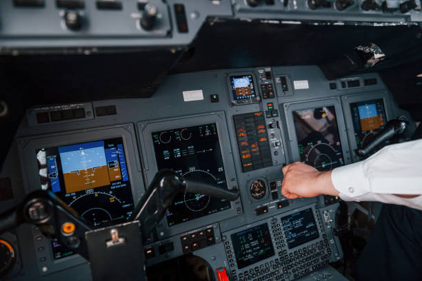 istock Close up view. Pilot on the work in the passenger airplane. Preparing for takeoff 1365849150
