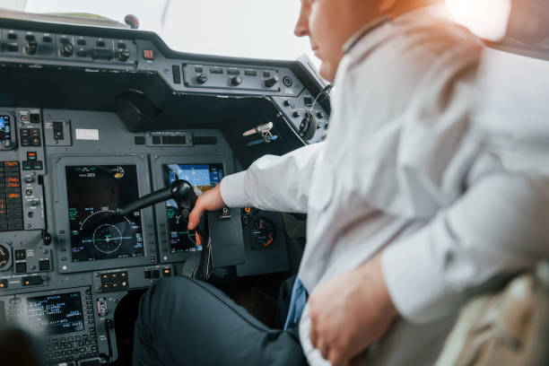 istock Close up view. Pilot on the work in the passenger airplane. Preparing for takeoff 1365849157