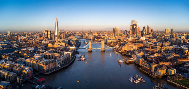 panoramic aerial view of the skyline of london in golden sunrise light - london england morning sunlight tower bridge imagens e fotografias de stock