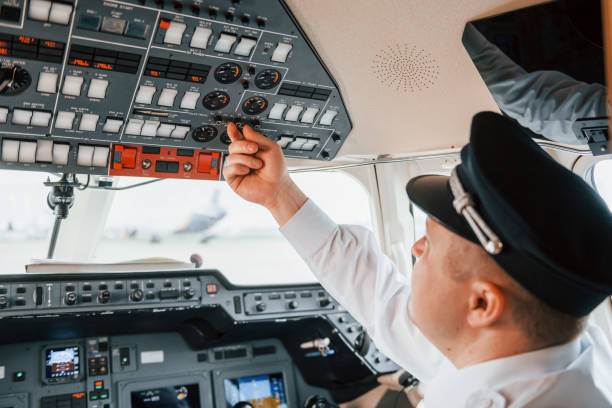 istock Close up view. Pilot on the work in the passenger airplane. Preparing for takeoff 1365849167