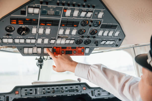 istock Close up view. Pilot on the work in the passenger airplane. Preparing for takeoff 1365849169