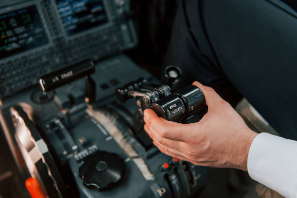 istock Close up view. Pilot on the work in the passenger airplane. Preparing for takeoff 1365849177