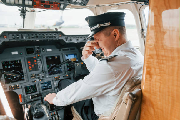 istock Pilot on the work in the passenger airplane. Preparing for takeoff 1365849181