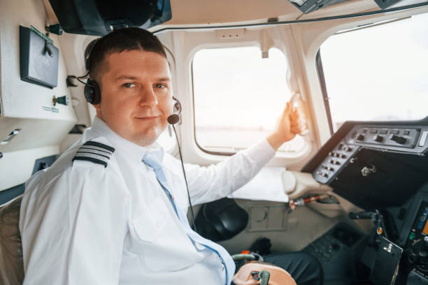 istock Pilot on the work in the passenger airplane. Preparing for takeoff 1365849186