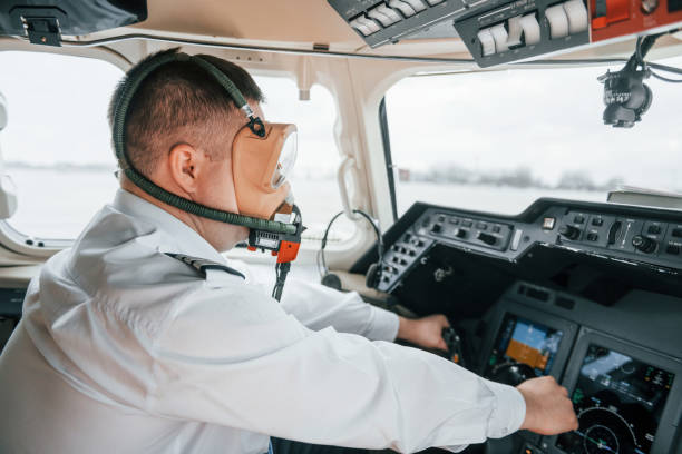 istock In oxygen mask. Pilot on the work in the passenger airplane. Preparing for takeoff 1365849197