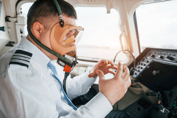 istock In oxygen mask. Pilot on the work in the passenger airplane. Preparing for takeoff 1365849198