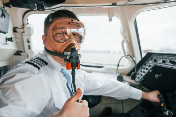 In oxygen mask. Pilot on the work in the passenger airplane. Preparing for takeoff.