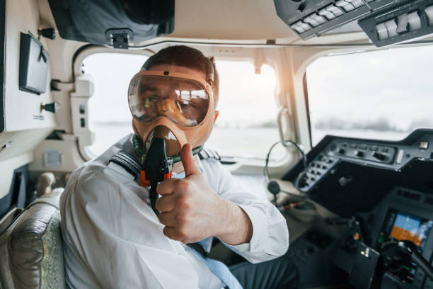 istock In oxygen mask. Pilot on the work in the passenger airplane. Preparing for takeoff 1365849224