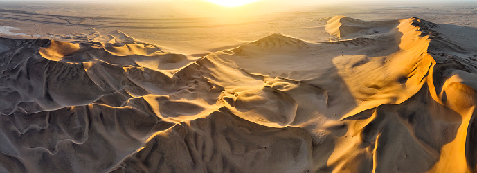 Sunrise over golden desert dunes in the desert