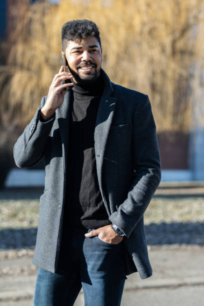 istock Confident businessman with mobile phone 1365852154