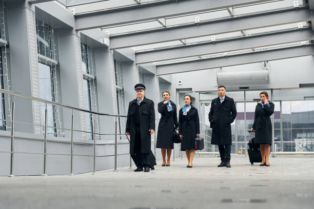 istock In uniform. Airplane crew in uniform is going to the work together 1365852229